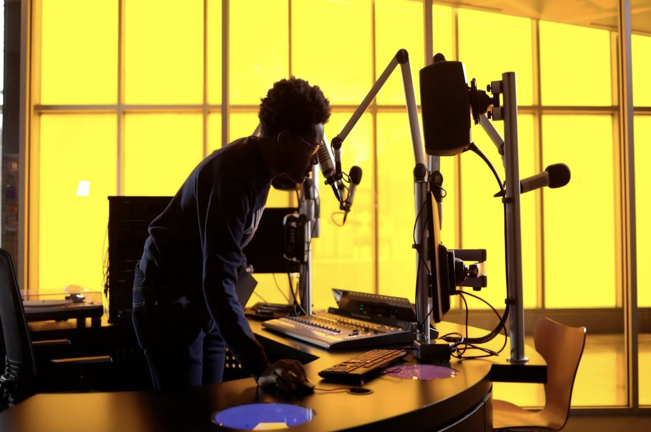 Photo of student in the WIIT 88.9 FM radio station