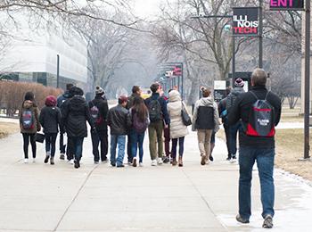 Students and their family members walking around Mies (main) campus