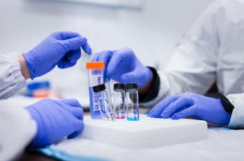 Photo of hands wearing gloves in biology lab