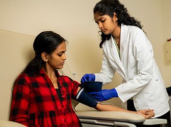 Illinois Tech students take blood pressure in the Center for Nutrition Research