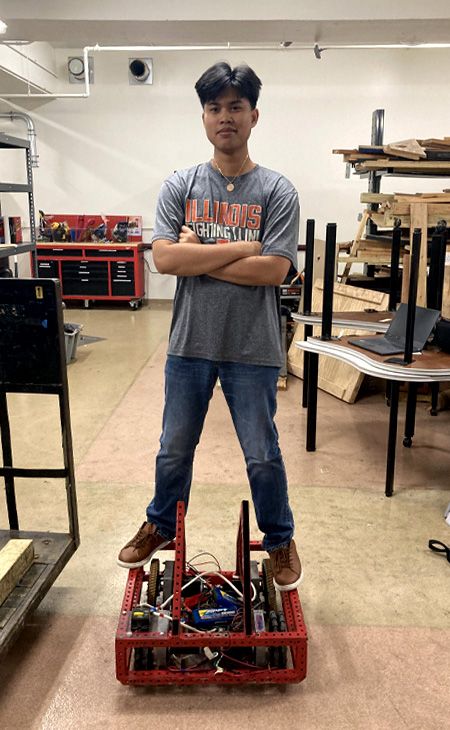 Photo of Robert John Soler (CCSE, M.A.S. CYF 5th Year) in front of a robotic device.