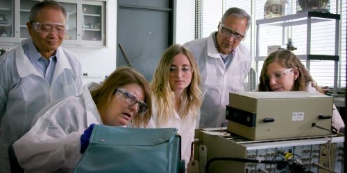Photo of students and faculty in physics lab