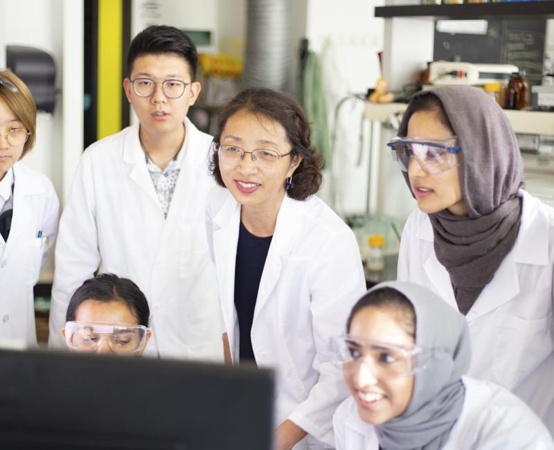 Jialing Xiang examines images with a group of students