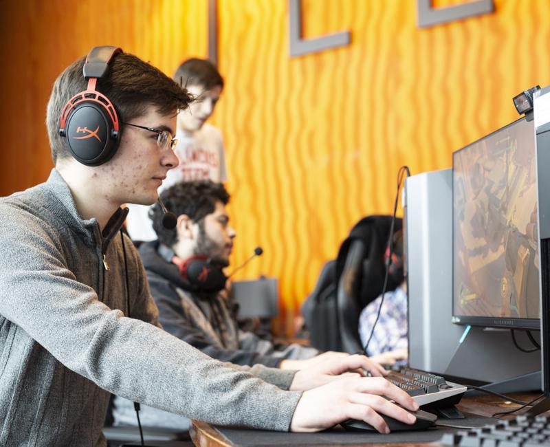 A student plays a video game in the Esports lab