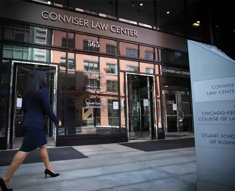 Exterior front of Conviser Law Center with woman in suit walking by